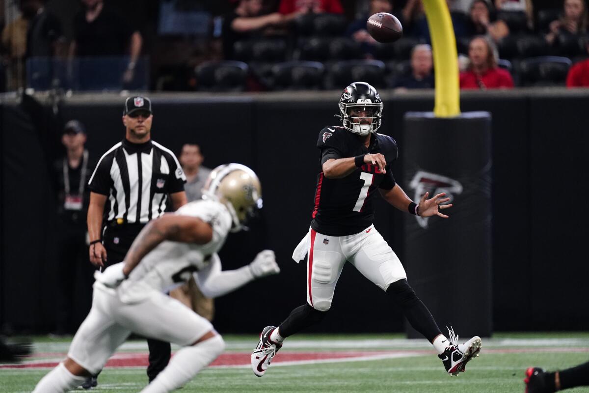 Atlanta Falcons quarterback Marcus Mariota (1) throws the ball on the run against the New Orleans Saints during the first half of an NFL football game, Sunday, Sept. 11, 2022, in Atlanta. (AP Photo/John Bazemore)