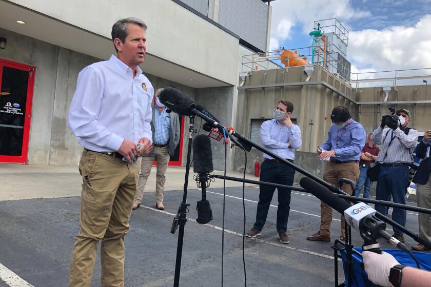Georgia Gov. Brian Kemp speaks to the media May 15 after touring a chicken processing plant in Gainesville, Ga.