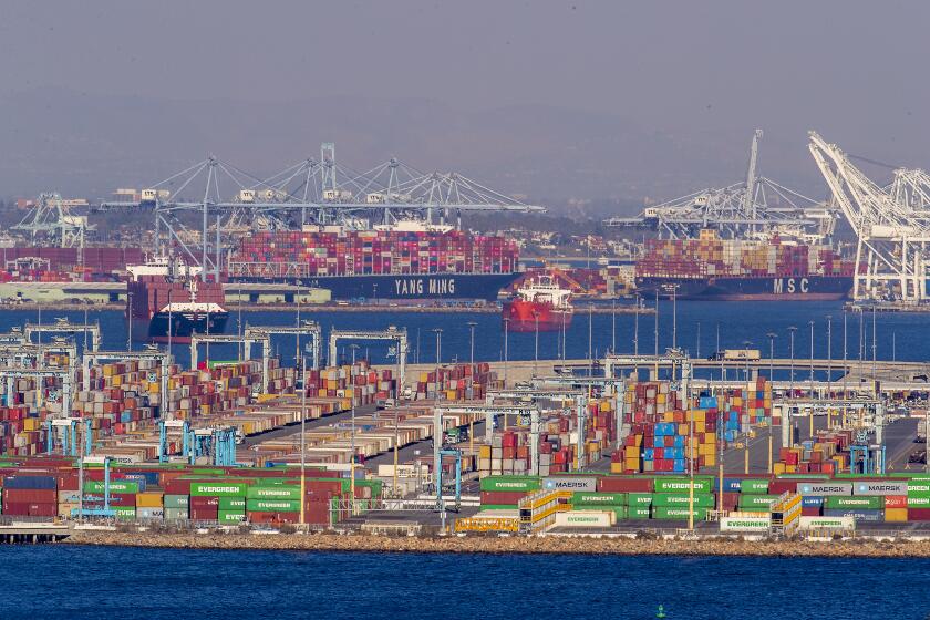 Long Beach, CA - October 13 Dozoens of container ships sit off the coast of the Ports of Los Angeles and Long Beach, waiting to be unloaded. :President Biden is set to announce Wednesday that the Port of Los Angeles would operate around the clock to alleviate a logistical bottleneck that has left dozens of container ships idling off the California coast and Americans waiting longer to get products manufactured overseas. The agreement to have longshoremen unloading cargo through the night is intended to speed the flow of toys, electronics and other gifts to American doorsteps during the holiday season. in on Wednesday, Oct. 13, 2021 in Long Beach, CA. (Allen J. Schaben / Los Angeles Times)