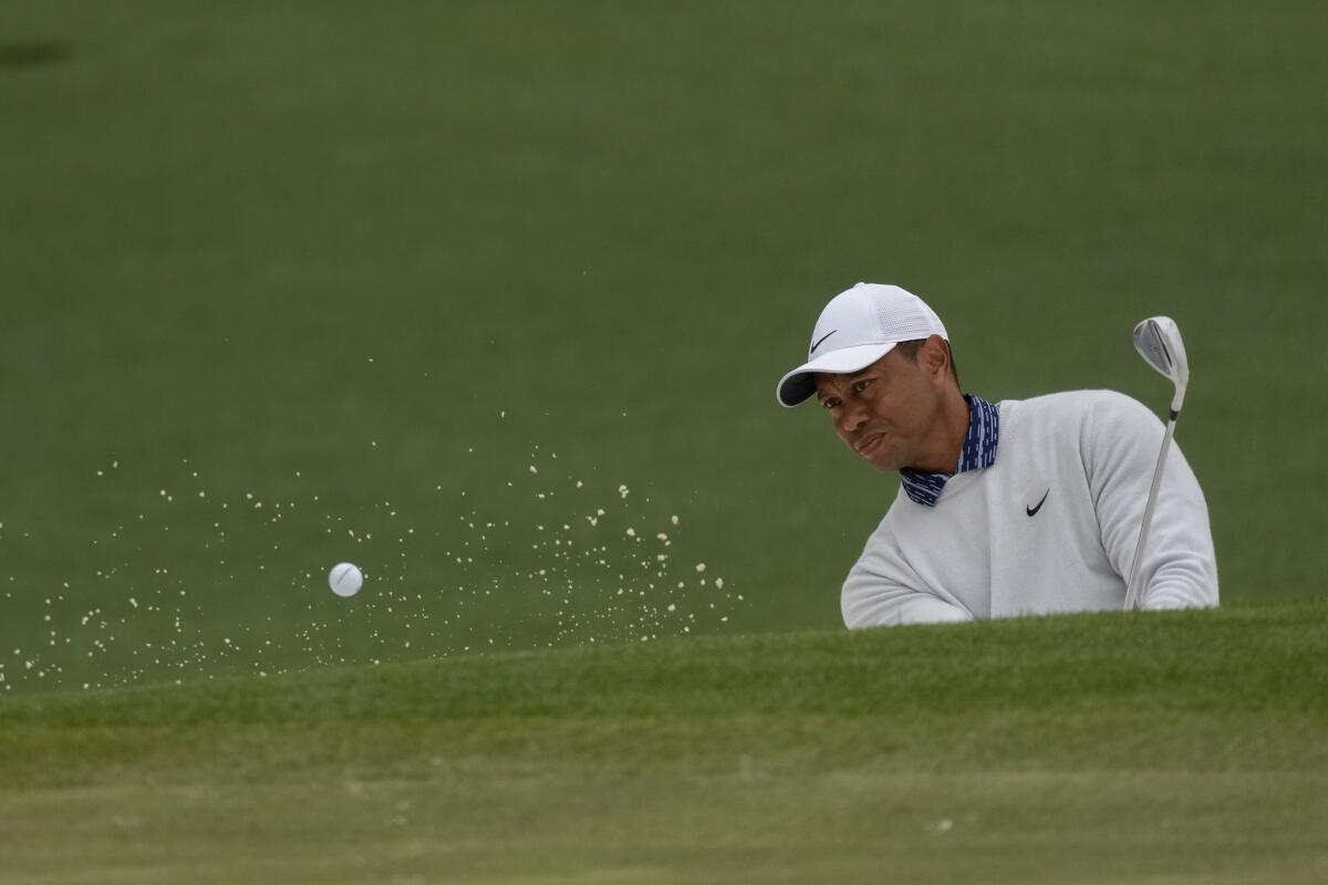 Tiger Woods hits out of a bunker on the second hole during the third round of the Masters.