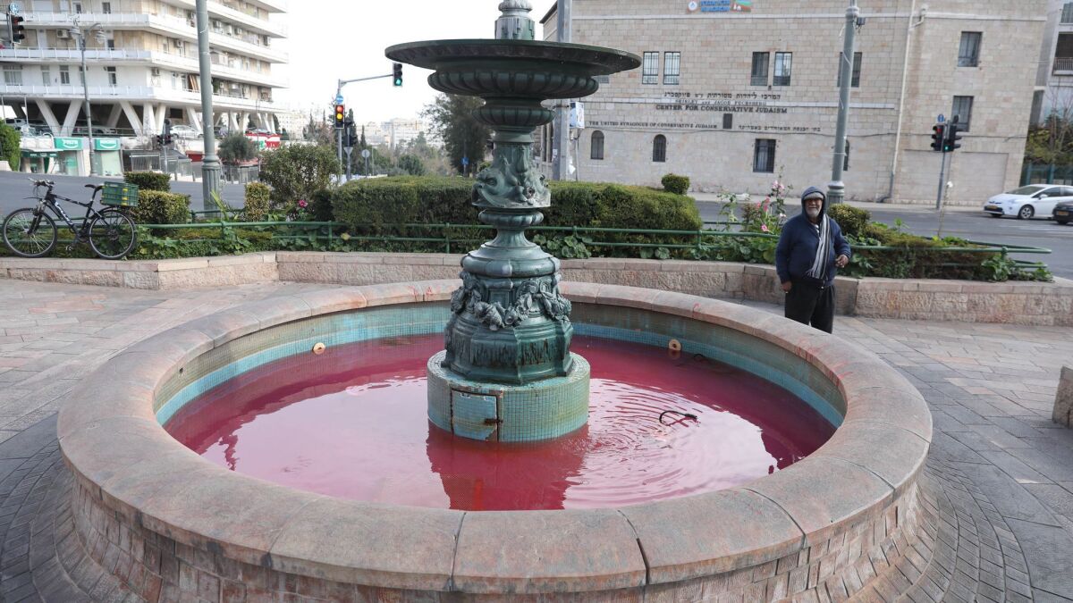 The fountain in Jerusalem's Paris Square is dyed red Monday as part of a protest over violence against women. A nationwide "women's strike" has been called for Tuesday after the slayings of two teen girls.