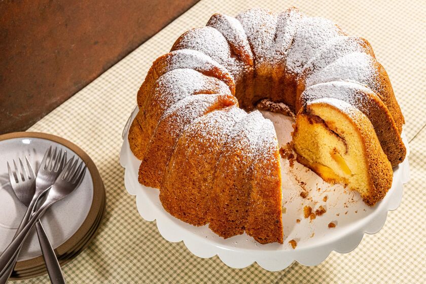 A cinnamon-apple Bundt cake dusted with powdered sugar.