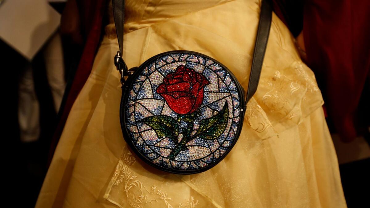 Jennifer Miyano, 32, of Hermosa Beach shows the rose purse she decorated in honor of "Beauty and the Beast," which had its first L.A. public screening Thursday at Hollywood's El Capitan Theatre.
