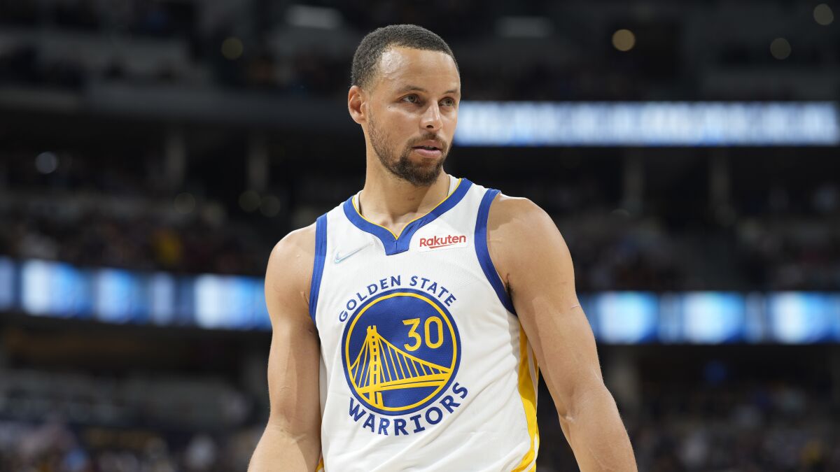 A professional basketball player in a jersey that says Golden State Warriors.