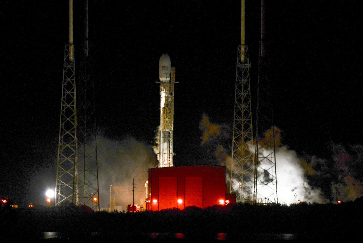 A SpaceX Falcon 9 rocket remains on the launch pad Sunday at Cape Canaveral Air Force Station.