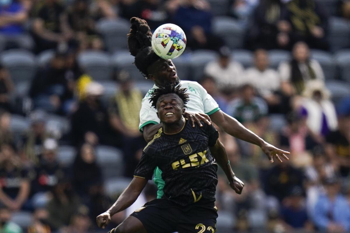 LAFC's Kwadwo Opoku, front, and Colorado's Lalas Abubakar jump for a header.