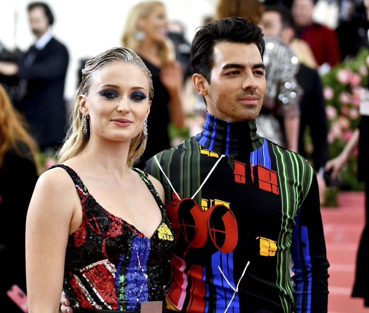 Sophie Turner and Joe Jonas wearing matching colorful outfits at the Met Gala