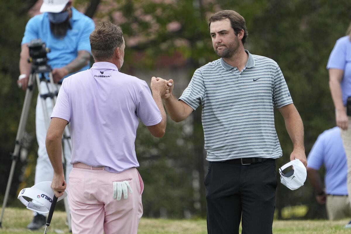 Scottie Scheffler, right, bumps fists with Ian Poulter after Scheffler won their match at the Dell Technologies Match Play.