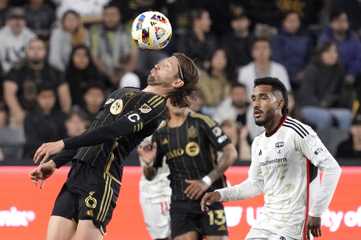 LAFC midfielder Ilie Sánchez, left, heads the ball in front of FC Dallas forward Jesús Ferreira.