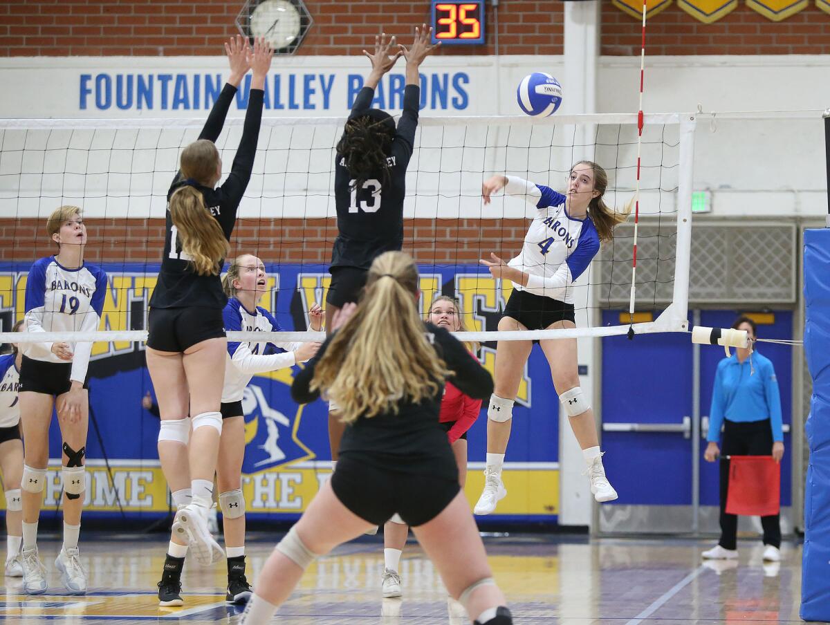 Fountain Valley's Phoebe Minch (4) puts a kill past Paloma Valley blockers Jayde Shelton (13) and Rachel Lowe in the quarterfinals of the CIF Southern Section Division 3 playoffs on Wednesday.