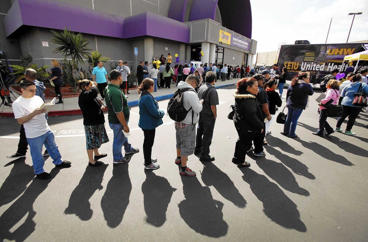 Californians brave long lines in the city of Commerce in 2014 to sign up for health coverage under the Affordable Care Act.