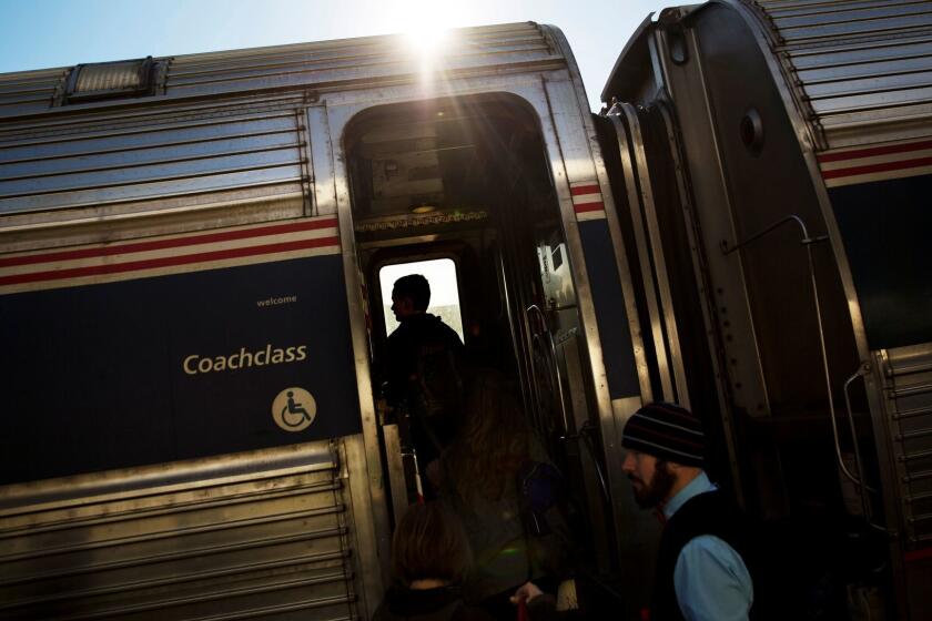 FILE - In this Nov. 23, 2016, file photo, passengers board an Amtrak train heading to New Orleans in Atlanta. An Amtrak passenger tweeted on Sunday, May 14, 2017, that he ordered a pizza to a stalled train traveling from New York to Washington, D.C. (AP Photo/David Goldman, File)