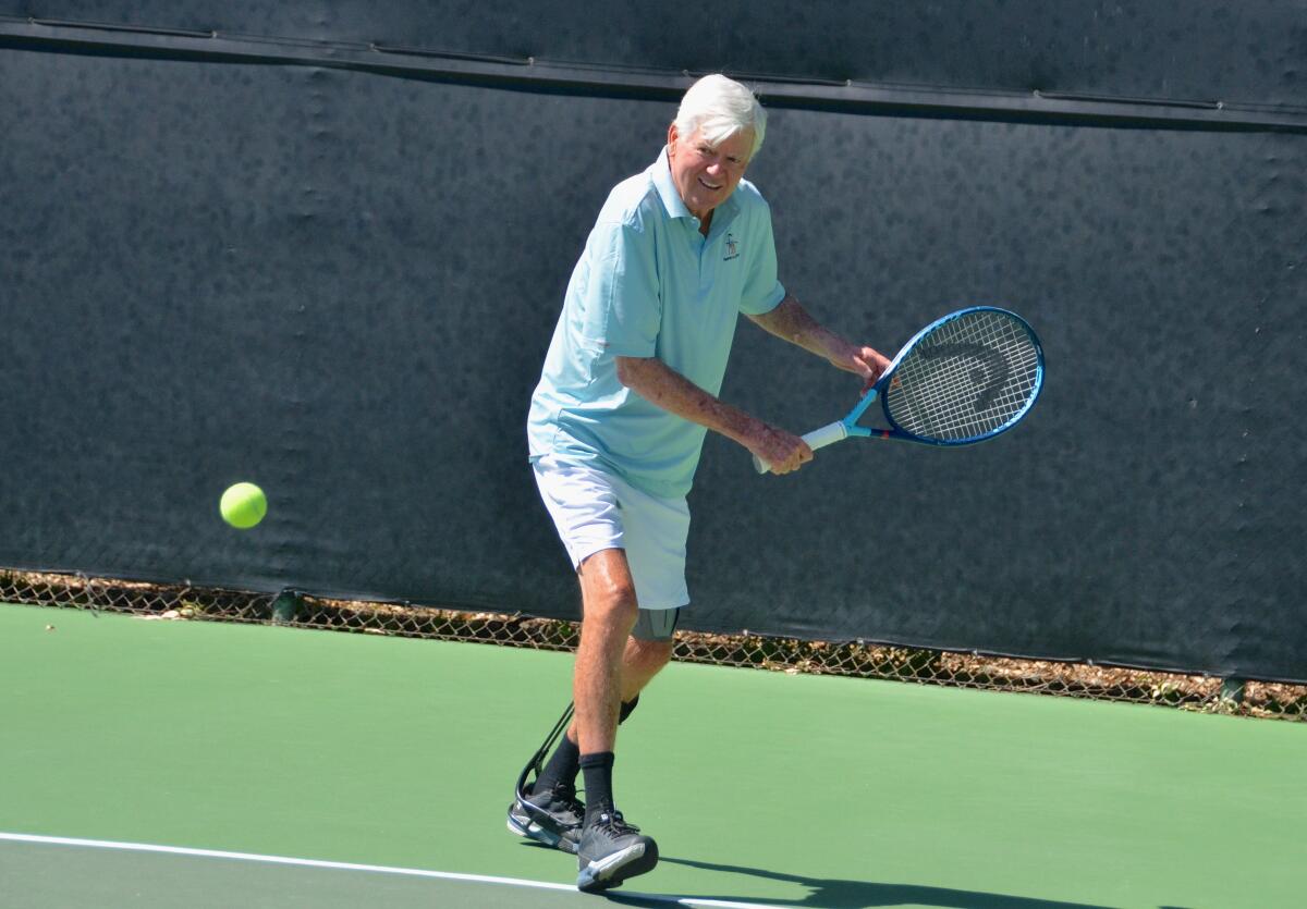 Larry Collins returns ball to opponent Monday at Palisades Tennis Club Newport Beach.