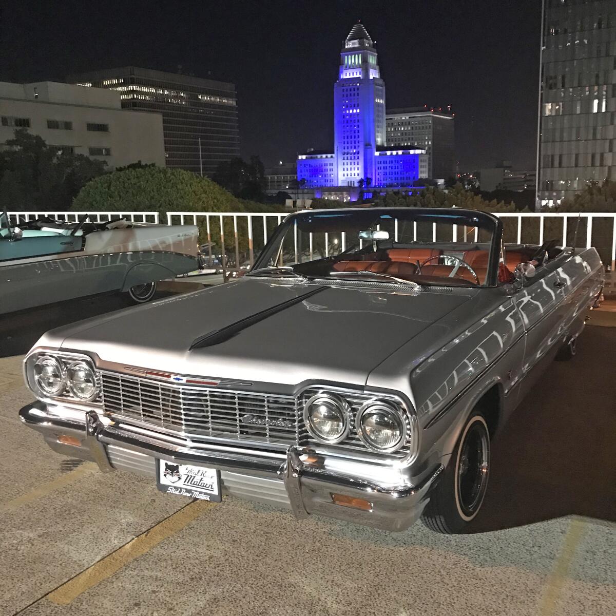 A 1964 Impala  with the Los Angeles skyline in the background
