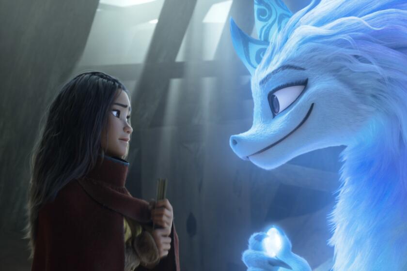 Animated character Raya, voiced by Kelly Marie Tran, left, appears with Sisu the dragon in a scene from "Raya and the Last Dragon." (Disney+ via AP)