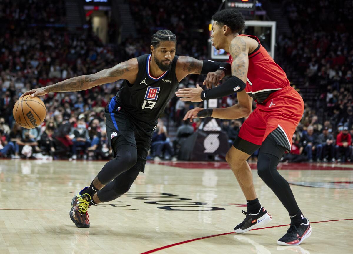 The Clippers' Paul George drives on the Trail Blazers' Anfernee Simons on Oct. 29, 2021.