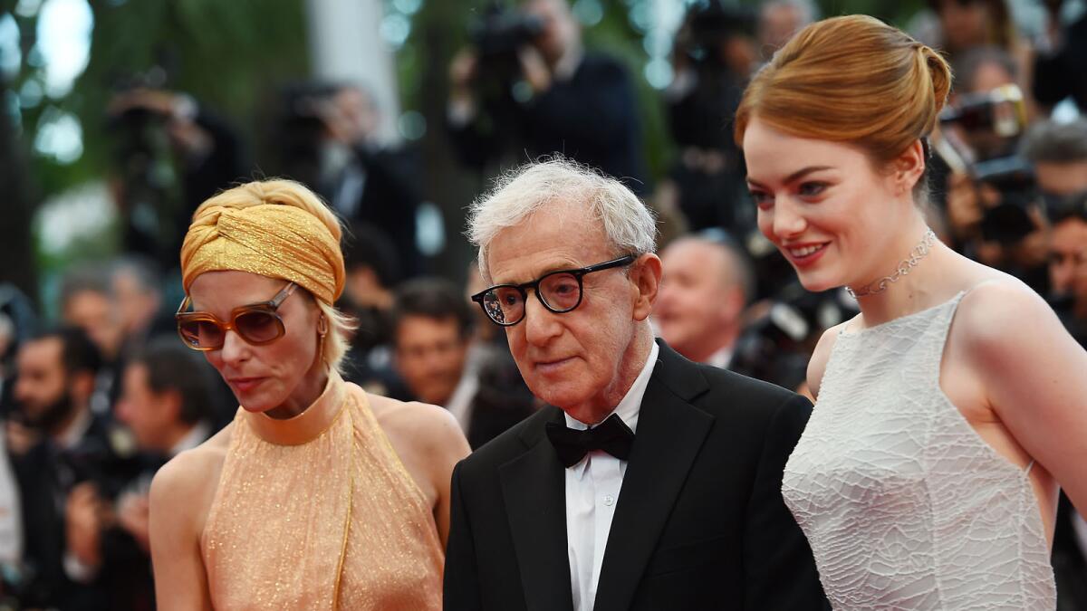 Woody Allen, center, poses with actresses Parker Posey, left, and Emma Stone as they arrive for the screening of the film "Irrational Man" at the Cannes Film Festival.