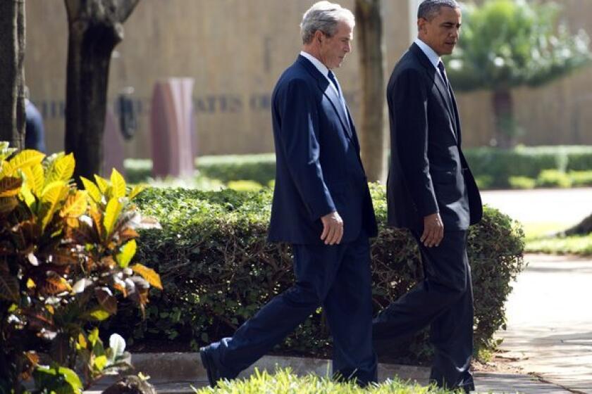 President Obama and his predecessor, George W. Bush, arrive for a wreath-laying ceremony for victims of the 1998 U.S. Embassy bombing in Dar es Salaam, Tanzania