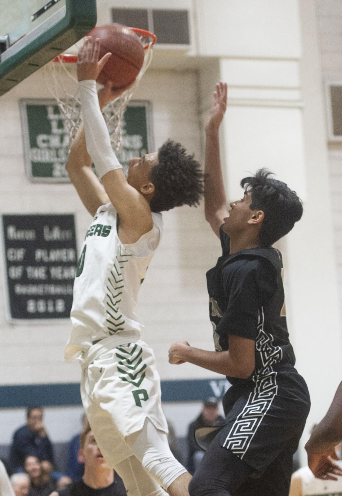 Providence’s Jordan Shelley goes to the hoop past Tustin’s Jason Naranj during Wednesday’s CIF Southern Section Division III-AA first-round playoff game at Providence. (Photo by Miguel Vasconcellos)