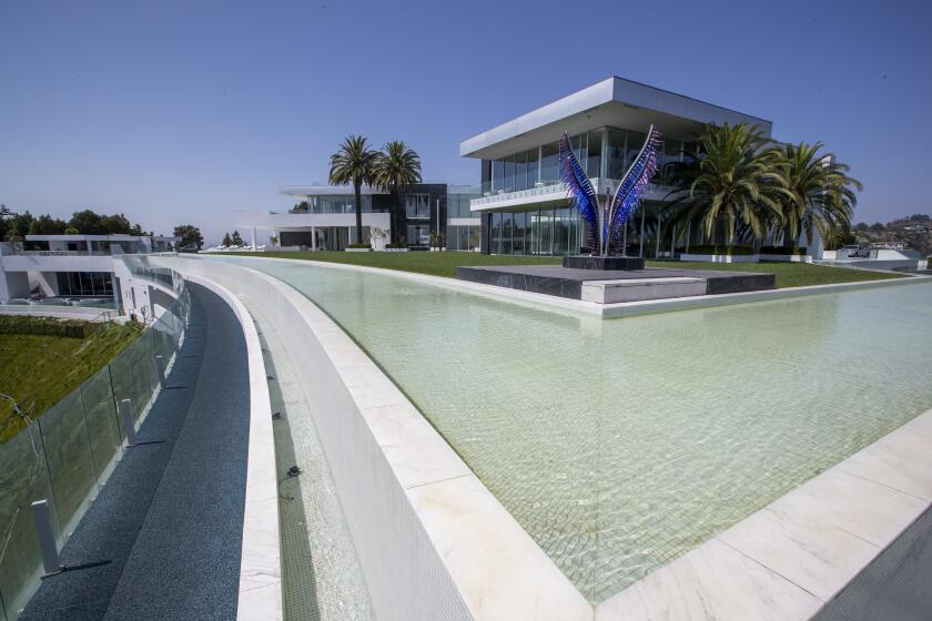 Beverly Hills, CA - September 08: An exterior view of "The One Bel Air", a 105,000-square-foot mansion with a sky deck and putting green, night club, several swimming pools, a 50-seat theater, a four-lane bowling alley, beauty salon, and more by Nile Niami of Skyline Development and designed by Paul McClean (McClean Design). The One is shown by court-appointed receiver Ted Lanes, who now controls the property and is in charge of finding a buyer and paying off the lenders and other creditors, gives a tour of The One, the 105,000 square foot house on sale in Bel Air. This is apparently the largest home for sale in the United States. The developer Nial Niami "listed" it for $500 million but got into financial trouble and was foreclosed upon by Don Hankey. Photo taken in Bel Air on Wednesday, Sept. 8, 2021 in Beverly Hills, CA. (Allen J. Schaben / Los Angeles Times)