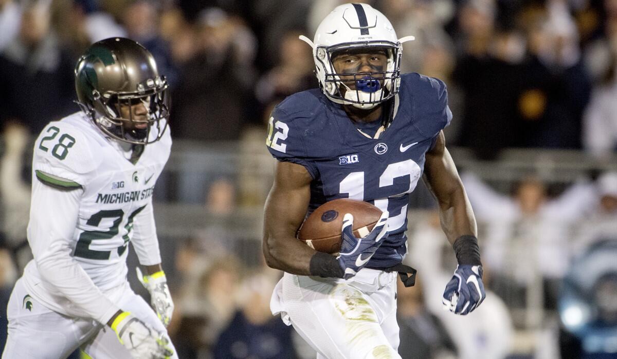 Penn State's Chris Godwin, right, runs in for a touchdown ahead of Michigan State's Madre London on Saturday.
