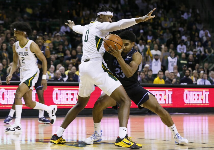 Baylor forward Flo Thamba, left, applies the defensive pressure on Villanova forward Jermaine Samuels, right, during the first half of an NCAA college basketball game on Sunday, Dec. 12, 2021, in Waco, Texas. (AP Photo/Ray Carlin)