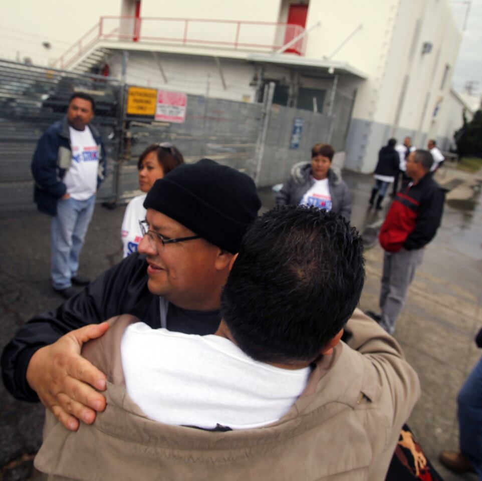 Striking workers at the Hostess Bakery in Los Angeles console each other after management announced it planned to liquidate the company.