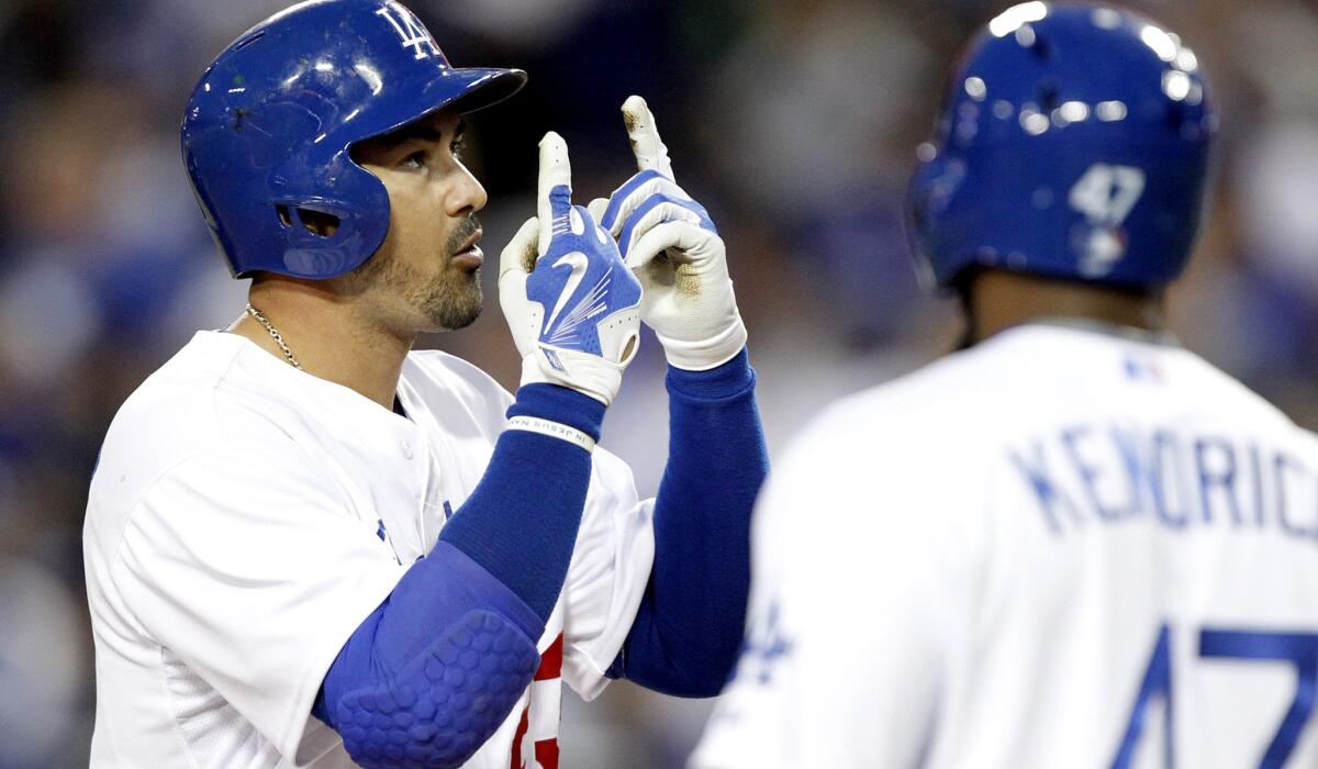 Dodgers first baseman Adrian Gonzalez celebrates at home plate after hitting the first of three home runs against the Padres on Wednesday night at Dodger Stadium.