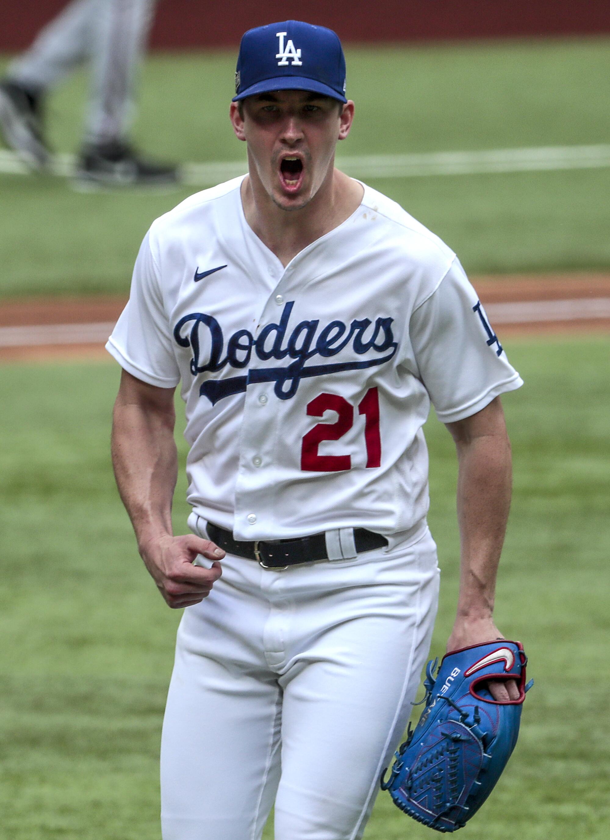 Dodgers starting pitcher Walker Buehler celebrates after getting out of a bases-loaded jam in the second inning.