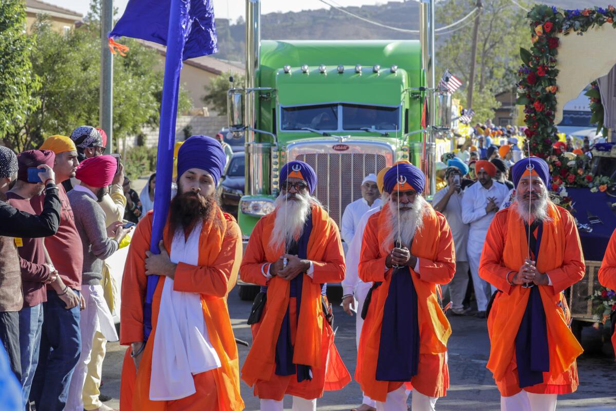 Sikh priests lead a Nagar Kirtan parade followed by a truck out of Palwinder Singh's temple in Jurupa Valley. Most families at the temple are involved in the growing Sikh trucking industry. (Irfan Khan / Los Angeles Times)