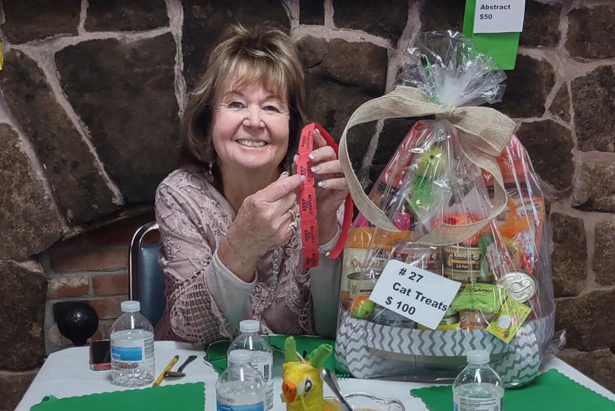 Ramona Womans Club Treasurer Carole Jewell won a gift basket containing $100 worth of cat treats.