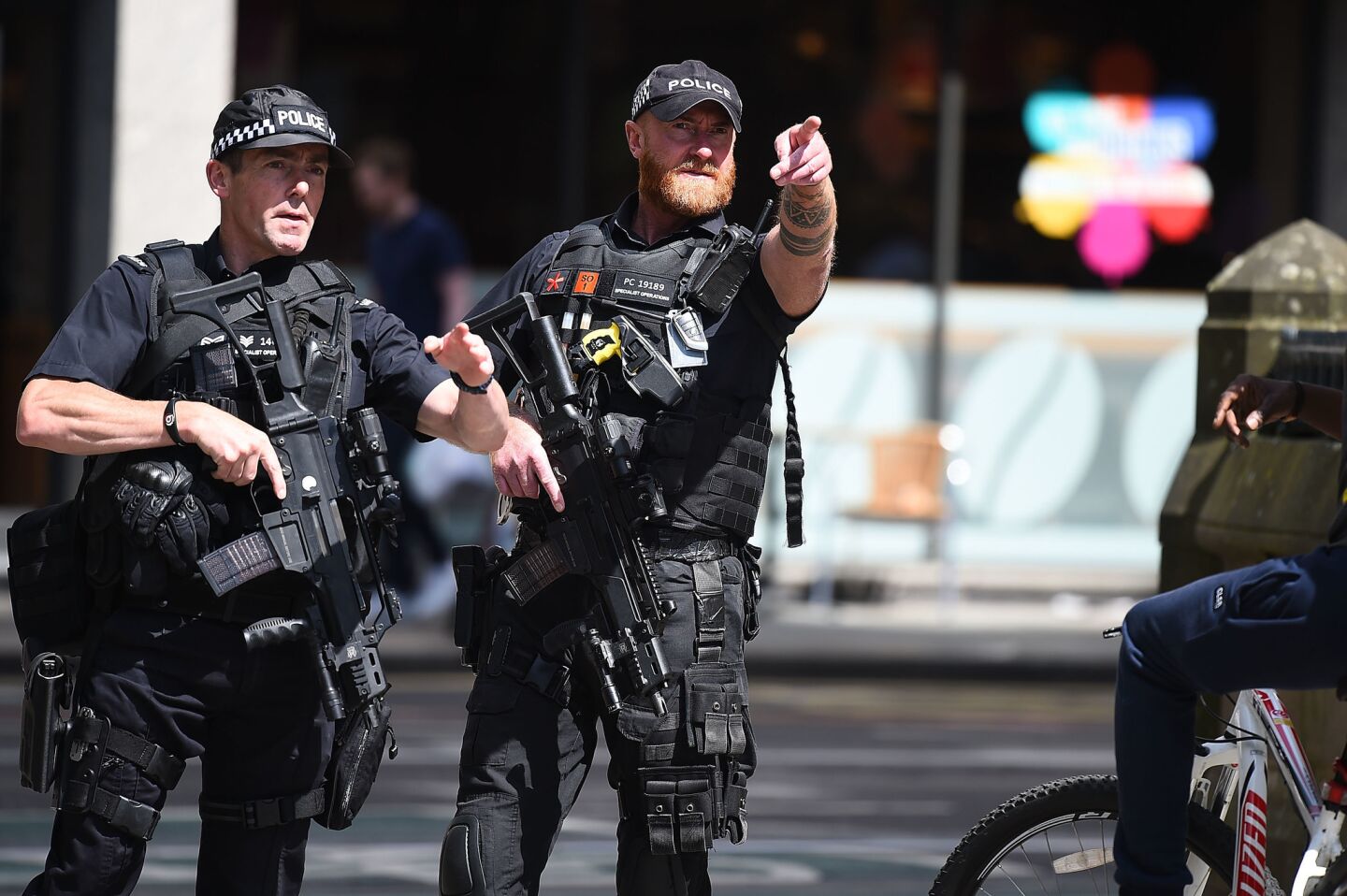 Police stand guard Tuesday near Manchester Arena, where 22 people were killed in a suicide bombing at an Ariana Grande concert the night before.