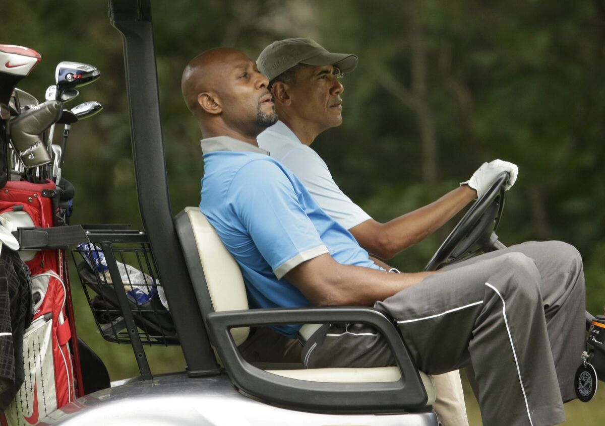 Former NBA star Alonzo Mourning and President Obama golf Sunday in Oak Bluffs, Mass., on the island of Martha's Vineyard.