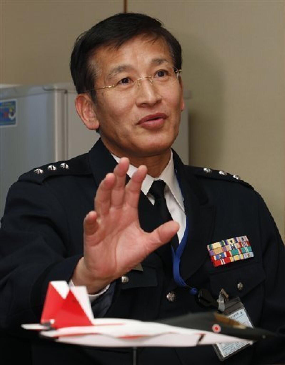 In this March 7, 2011 photo, Lt. General Hideyuki Yoshioka speaks during an interview with The Associated Press at Defense Ministry in Tokyo. Yoshioka, the director of the air systems development at the ministry, said Japan is on track to test a domestically designed prototype stealth fighter in three years. The fighter model is shown in the foreground. (AP Photo/Shizuo Kambayashi)