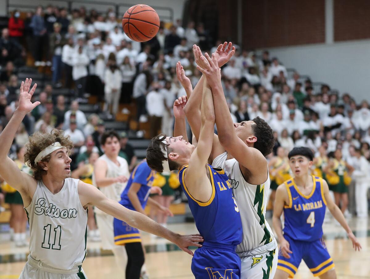 Edison's Trey Wilborn drives to the basket and is met by La Mirada's Julien Gomez, who breaks up the play.