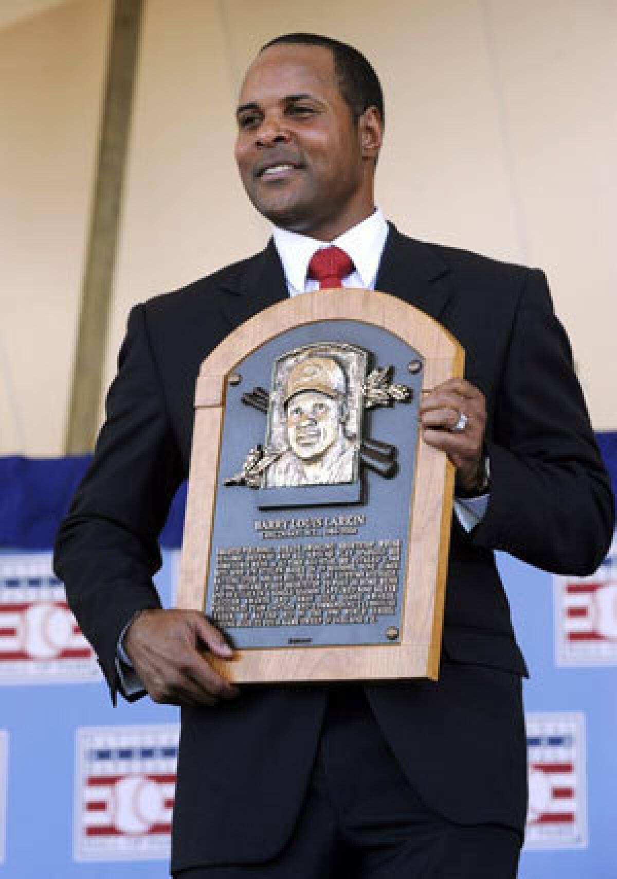 Former Cincinnati Reds star Barry Larkin holds his plaque after his induction into the Hall of Fame.