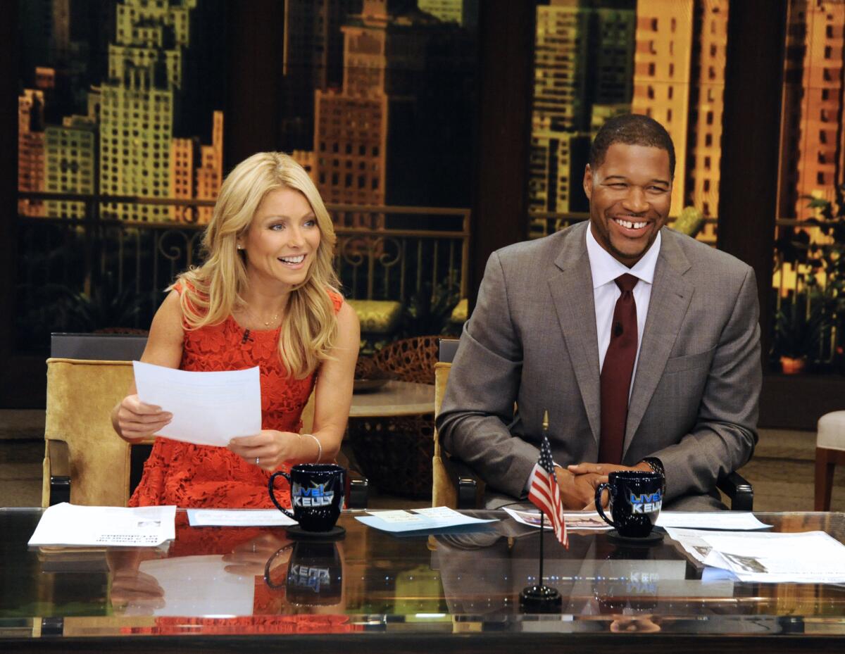 This undated photo shows former football player Michael Strahan, right, and host Kelly Ripa during Strahan's guest-host appearance on "Live," before he joined the show full time in 2012.