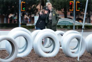 Malibu, California February 26, 2024-Fifty year Malibu resident Tina Siegel and L.A. County Sheriffs Captain Jenn Seeto comfort each other after adding another Ghost Tire to a memorial bringing the number to fifty nine, in honor of every person killed along Pacific Coast Highway in Malibu since 2010. The latest Ghost Tire is being placed in honor of 32-year-old Jose Alfonso De Lira Piedra. (Wally Skalij/Los Angeles Times)