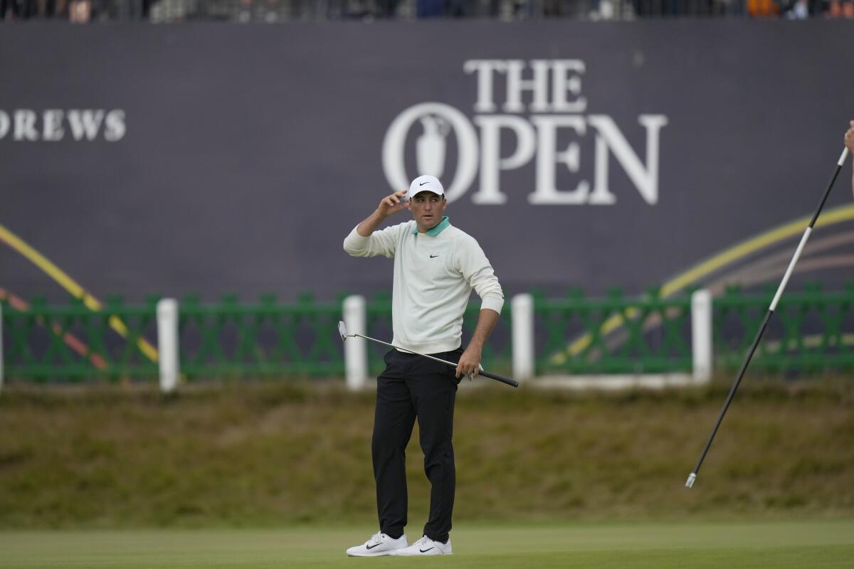 Scottie Scheffler of the US after putting on the 18th green during the third round of the British Open golf championship on the Old Course at St. Andrews, Scotland, Saturday July 16, 2022. (AP Photo/Alastair Grant)