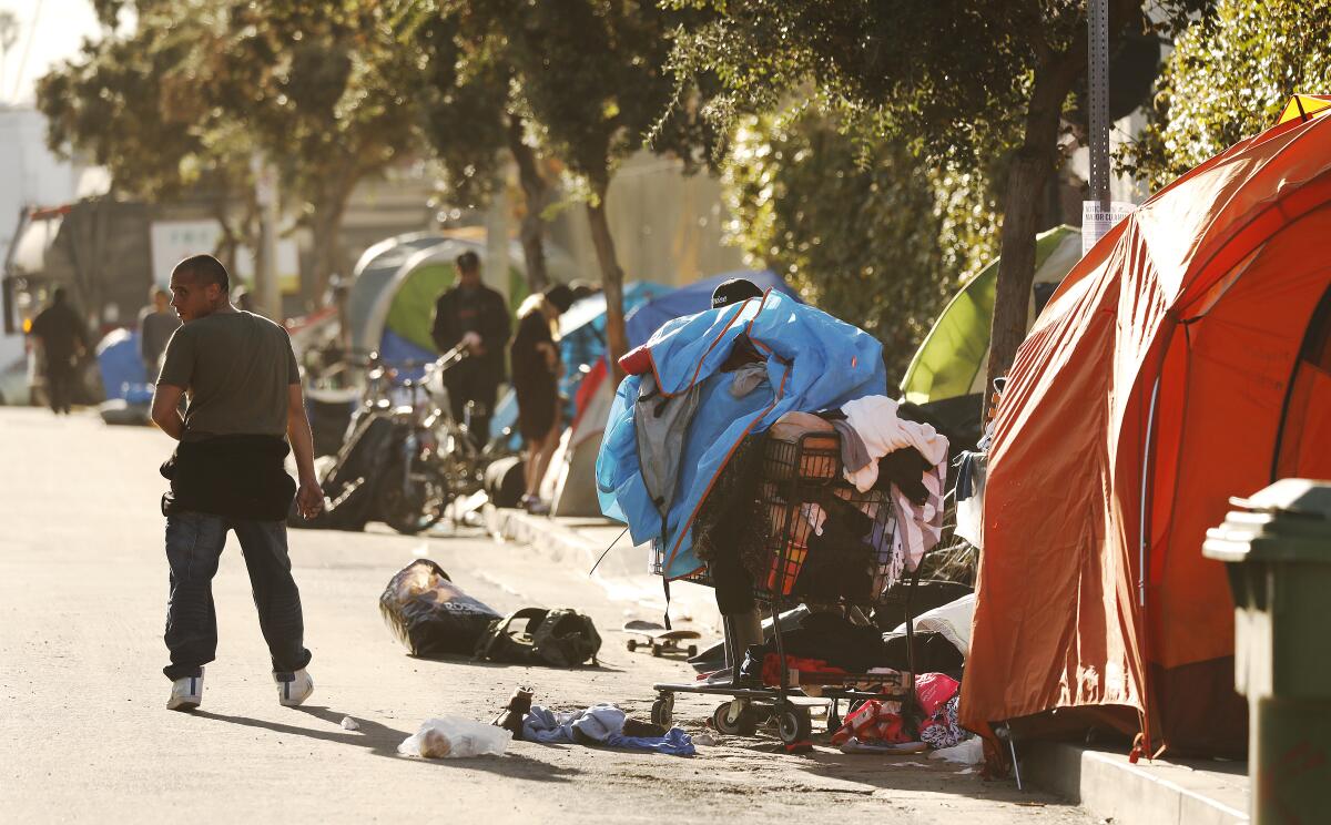 Homeless people in Venice with tents and shopping carts full of possessions.