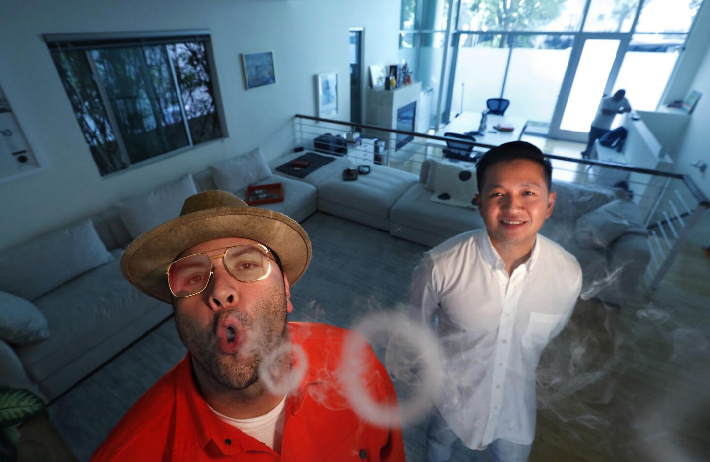 Will Htun, right, is chief executive of the Sherbinskis cannabis brand. His sleek, minimal live/work space is meant to be comfortable for both activities. Founder Mario Sherbinski makes himself at home.