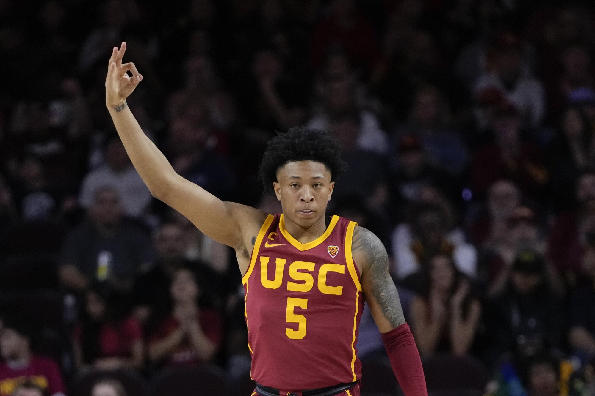 USC guard Boogie Ellis holds up three fingers to celebrate after hitting a three-pointer against rival UCLA on Jan. 27. 