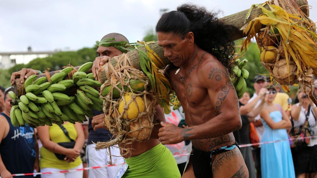 Athletes honor Polynesia during a festival in Papeete, the capital of the French Polynesian island of Tahiti.