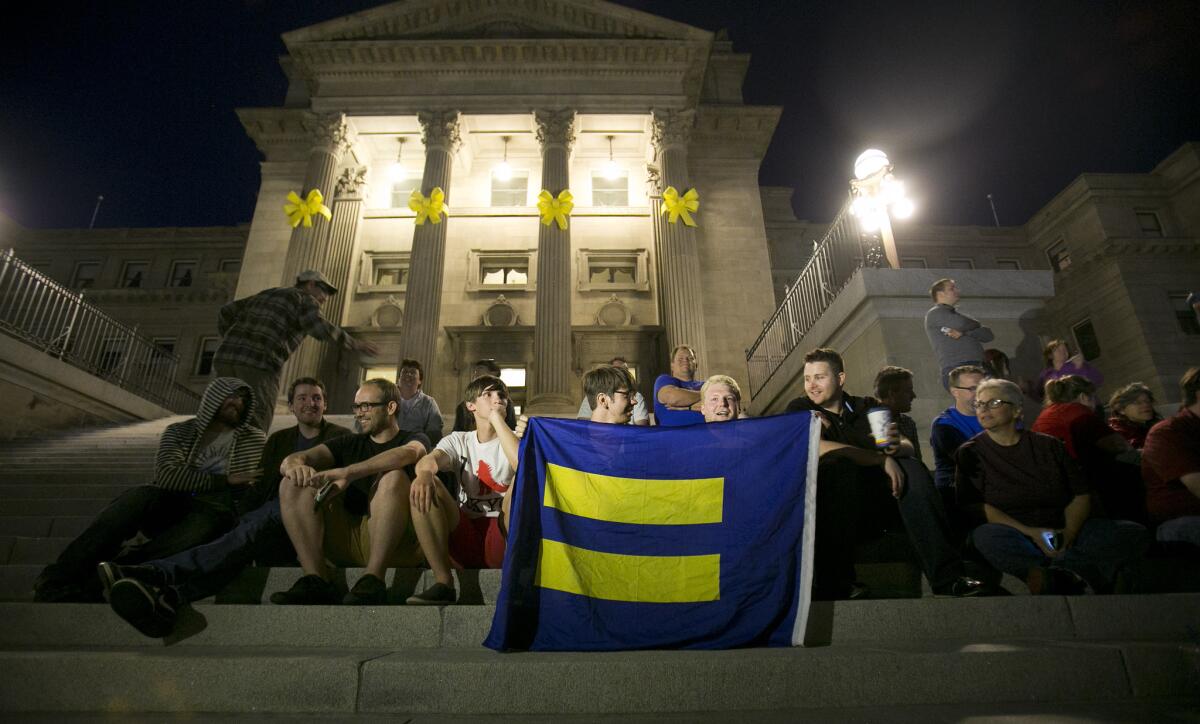 Same-sex marriage supporters gather on the steps of the Idaho Statehouse in Boise on Tuesday after U.S. Magistrate Judge Candy Wagahoff Dale ruled earlier in the day that Idaho's ban on gay marriage is unconstitutional.