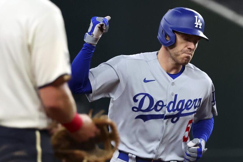 Los Angeles Dodgers' Freddie Freeman (5) pumps his fist as he runs the bases after a home run in the fifth inning.