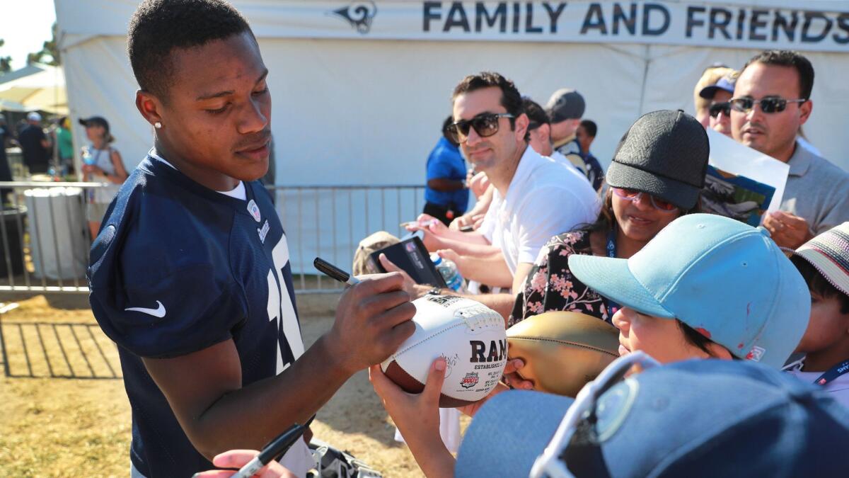 Rams wide receiver Pharoh Cooper signs autographs for fans during the team's training camp.