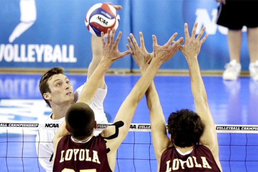Zack La Cavera hits against Loyola-Chicago's Thomas Jaeschke and Nicholas Olson in the second set of UC Irvine's sweep of the Ramblers on Thursday night at Pauley Pavilion in the NCAA men's volleyball semifinals.
