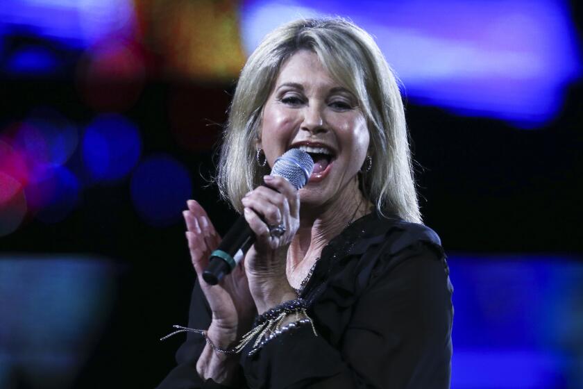 FILE - In this Thursday, Feb. 23, 2017 file photo, Olivia Newton John performs during the Vina del Mar International Song Festival at the Quinta Vergara in Vina del Mar, Chile. Britain’s Cabinet Office published Friday Dec. 27, 2019, the list of the people receiving honors for merit, service or bravery. “Grease” star Newton-John was made a dame — the female equivalent of a knight — for her singing and acting and also for her charitable work supporting cancer research. (AP Photo/Esteban Felix, File)