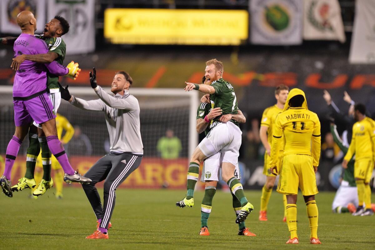 Timbers teammates celebrate with goalkeeper Adam Kwarasey (12) after Portland defeated Columbus Crew SC, 2-1, to win the MLS Cup title.
