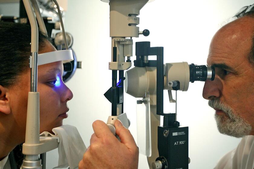 House, Christina   COMPTONCAJANUARY 13, 2010: Sophia Taylor, 24, of Long Beach, left, receives an eye exam from Optometrist Dr. Jay H. Messinger at his office in Compton on Wednesday, January 13, 2010. Messinger runs the only Optometry office in Compton. (Christina House / For The Times)